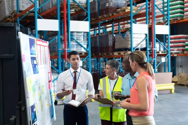 warehouse-staffs-discussing-whiteboard-warehouse-1-66d442ca56556